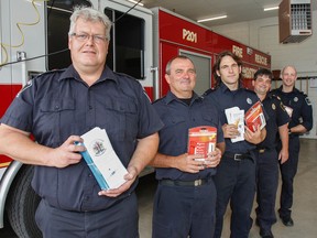 The Kingston Fire and Rescue suppression crew out of Station 10, along with fire inspector Richard Edworthy, second from back, show off some of the smoke alarms and educational information on Friday July 8, 2016, that is used in the annual Wake Up Kingston smoke alarm program running this summer in Kingston, Ont.. Julia McKay/The Whig-Standard/Postmedia Network