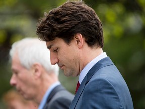 Prime Minister Justin Trudeau walks next to Foreign Affairs minister Stéphane Dion after speaking to media at the Delta Lodge at Kananaskis west of Calgary, Alta., on Tuesday, April 26, 2016. (Lyle Aspinall/Postmedia Network)