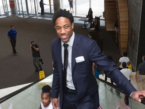 DeMar DeRozan arrives with his daughter Diar as the Toronto Raptors announced the signings of DeRozan and Jared Sullinger at the Real Sports in Toronto on July 14, 2016. (Stan Behal/Toronto Sun/Postmedia Network)