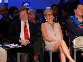 Toronto Mayor John Tory and Ontario Premier Kathleen Wynne listen to  speakers at the first anti-racism meeting arranged by the Ontario government. They faced a lot of anger and criticism at the Regent Park meeting on Thursday July 14, 2016. Michael Peake/Toronto Sun/Postmedia Network
