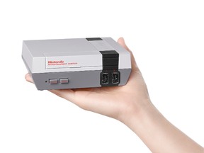 This undated product image provide by Nintendo of America shows the Nintendo Entertainment System Classic edition that comes complete with 30 built-in games, including all three "Super Mario Bros.," ''Donkey Kong," ''The Legend of Zelda," and "Punch-Out." Nintendo says it's bringing back the wildly popular system that launched in the 1980s so those who grew up with it can pass gaming memories onto the next generation. The system goes on sale Nov. 11, 2016. (Nintendo of America via AP)
