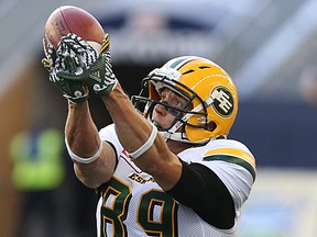 Eskimos receiver Chris Getzlaf reaches to pull down a pass from Mike Reilly in the first half of Thursday's game at Investors Group Field in Winnipeg. (Kevin King)