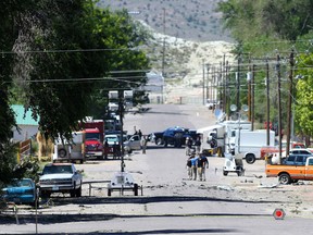 Police investigate shrapnel from a Wednesday night bombing that killed one person on 5th Street in Panaca, Nev., on Thursday, July 14, 2016. (Brett Le Blanc/Las Vegas Review-Journal via AP)
