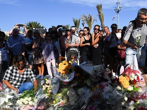 People visit the scene and lay tributes to the victims of a terror attack on the Promenade des Anglais on July 15, 2016 in Nice, France. (Photo by David Ramos/Getty Images)