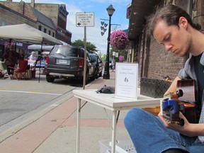 Justin Brown, a Sarnia-raised flamenco guitarist now based in Toronto, performs as part of the International Symhony Orchestra Random Acts of Culture project on Friday July 15, 2016 at the weekly farmers market in Forest, Ont. Paul Morden/Sarnia Observer/Postmedia Network