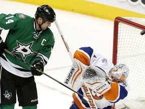 Dallas Stars forward Jamie Benn (14) tips a shot over New York Islanders goalie Thomas Greiss (1) during a game Saturday, March 19, 2016, in Dallas. (AP Photo/Brandon Wade)