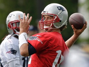 New England Patriots quarterback Tom Brady, right, winds up for a pass during a practice Tuesday, June 7, 2016, in Foxborough, Mass. (AP Photo/Steven Senne)