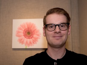 First-time photographer David Schuster with his photo of a pink daisy at the Melcor Cultural Centre in Spruce Grove on Monday, July 11, 2016. Schuster’s pink daisy won first place in the Allied Arts Council Open Photography competition. - Photo by Yasmin Mayne