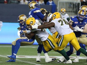 Winnipeg Blue Bombers QB Drew Willy is sacked by Edmonton Eskimos DL Odell Willis during CFL action in Winnipeg on Thu., July 14, 2016. Kevin King/Winnipeg Sun/Postmedia Network