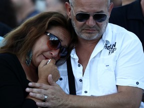 A woman is comforted as she weeps on the Promenade des Anglais on July 15, 2016 in Nice, France. A French-Tunisian attacker killed 84 people as he drove a lorry through crowds, gathered to watch a firework display during Bastille Day Celebrations. The attacker then opened fire on people in the crowd before being shot dead by police.  (Photo by Carl Court/Getty Images)