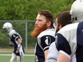 Sudbury Spartans linebacker Erik Conrad watches warmups prior to a game earlier this season. Conrad has taken on a greater leadership role this season. Ben Leeson/The Sudbury Star/Postmedia Network