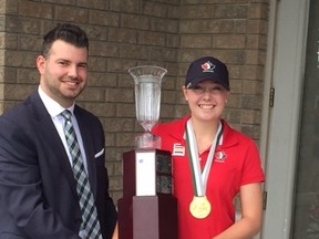 Ottawa golfer Grace St-Germain receives the provincial amateur women’s championship trophy from Patrick Dobmeier in Windsor. (Jim Parker, Windsor Star)