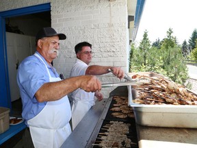 John Lappa/Sudbury Star file photo
George Alexakis, left, and Jim Danakas barbecue marinated chicken breasts and pork souvlaki at the annual Greek Festival at St. Nicholas Greek Orthodox Church last summer.