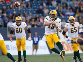 Edmonton Eskimos quarterback Mike Reilly (13) throws against the Winnipeg Blue Bombers during the first half of CFL action in Winnipeg Thursday, July 14, 2016.