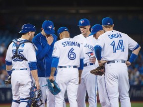 Toronto Blue Jays pitching coach Pete Walker, second left, come out to the mound to speak with Toronto Blue Jays starting pitcher Marcus Stroman during fifth inning AL baseball action in Toronto on Tuesday, May 17, 2016. (THE CANADIAN PRESS/Nathan Denette)