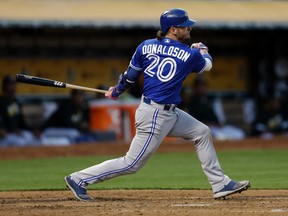 Josh Donaldson of the Toronto Blue Jays watches his RBI single off Oakland Athletics pitcher Daniel Mengden during the fourth inning July 15, 2016, in Oakland, Calif. (BEN MARGOT/AP)