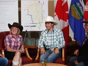Prime Minister Justin Trudeau speaks with Alberta Premier Rachel Notley and Calgary Mayor Naheed Nenshi during his visit to the Calgary Stampede on Friday, July 15, 2016. Trudeau said the federal government will put up to $582.9 million into the southwest portion of Calgary’s ring road, with the province paying for the balance.