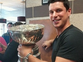 Pittsburgh Penguins' Sidney Crosby poses with the Stanley Cup inside a local Tim Horton's in his hometown of Cole Harbour, N.S., in a July 15, 2016, handout photo. THE CANADIAN PRESS/HO-J. Clarkson