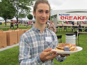 Sasha Tatiev, a resident of Moscow who was visiting relatives in Sarnia, volunteered at the Rotary Club of Sarnia Mackinac breakfast on Saturday July 16, 2016 in Point Edward, Ont. Approximately 100 volunteers help out at the annual event that serves some 2,000 breakfast to crowds who gather on the waterfront to watch sailboats leave Port Huron for the starting line of the Mackinac race.
Paul Morden/Sarnia Observer/Postmedia Network