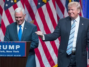 Republican presidential candidate Donald Trump, right, introduces Gov. Mike Pence, R-Ind., during a campaign event to announce Pence as the vice presidential running mate on, Saturday, July 16, 2016, in New York. (AP Photo/Evan Vucci)
