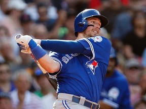 Toronto Blue Jays' Justin Smoak follows through on an RBI-single during the fourth inning of a baseball game against the Boston Red Sox Saturday, June 4, 2016, in Boston. (AP Photo/Michael Dwyer)