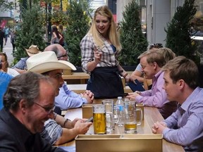 Server Macalyn Ahern attends to customers at Calgary’s Earl’s 67 location on July 12, 2016.