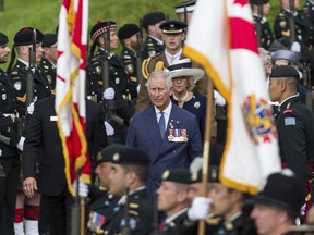 Britain's Prince of Wales, Prince Charles, center, followed his wife Camilla, reviews a Canadian honor guard before attending a memorial ceremony marking the centenary anniversary of the disastrous start to the Somme campaign in the First World War at the Canadian WWI Beaumont-Hamel Newfoundland Memorial in Beaumont Hamel, northern France, Friday, July 1st, 2016.  Charles and Camilla were to pay tribute to Northern Irish and Canadian soldiers in two separate events in Thiepval and in the nearby village of Beaumont-Hamel. (AP Photo/Kamil Zihnioglu)