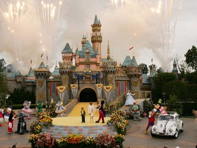 Fireworks explode under cloudy skies as Disney dignitaries and characters appear in front of Sleeping Beauty Castle at the close of ceremonies for the 50th anniversary of Disneyland May 5, 2005 in Anaheim, Calif.  (Photo by David McNew/Getty Images)