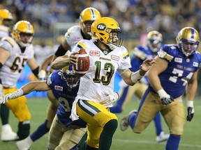 Edmonton Eskimos QB Mike Reilly scrambles during CFL action against the Winnipeg Blue Bombers in Winnipeg on Thu., July 14, 2016. Edmonton won the game 20-16.