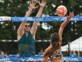A Super Spike competitor swings against the block of an opponent during action at Maple Grove Rugby Park on Saturday. The annual tournament is having to shift its focus for fundraising after the national women's volleyball team announced it was moving to B.C. (KEVIN KING/WINNIPEG SUN/POSTMEDIA NETWORK)