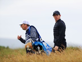 Rory McIlroy walks off the third tee with his caddie, J.P. Fitzgerald, during the third round of the British Open at Royal Troon on July 16, 2016 in Troon, Scotland. (Photo by Matthew Lewis/Getty Images)