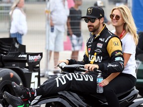 James Hinchcliffe gives his girlfriend, Becky Dalton, a lift trackside ahead of the Honda Indy Toronto qualifying session Saturday July 16, 2016. (Dave Abel/Toronto Sun/Postmedia Network)