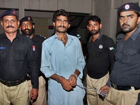 Pakistani police officers present Waseem Azeem, the brother of slain model Qandeel Baloch, before the media following his arrest at a police station in Multan, Pakistan, Sunday, July 17, 2016. (AP Photo/Asim Tanveer)
