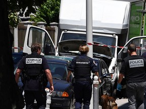 French police officers search a truck in a street of Nice on July 15, 2016, near the building where the man who drove a truck into a crowd watching a fireworks display the day before reportedly lived. (ANNE-CHRISTINE POUJOULAT/AFP/Getty Images)