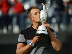 Henrik Stenson of Sweden kisses the trophy after winning the British Open Golf Championship at the Royal Troon Golf Club in Troon, Scotland, Sunday, July 17, 2016. (AP Photo/Matt Dunham)