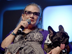 Carrie Fisher and dog Gary on stage during Future Directors Panel at the Star Wars Celebration 2016 at ExCel on July 17, 2016 in London, England.  (Photo by Ben A. Pruchnie/Getty Images for Walt Disney Studios)