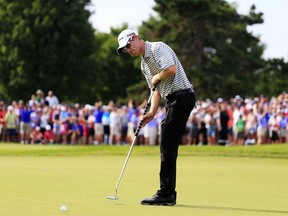 David Hearn of Canada putts on the 18th green during the final round of the RBC Canadian Open at Glen Abbey Golf Club on July 26, 2015 in Oakville, Canada. (Cliff Hawkins/Getty Images/AFP)