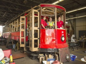 Ottawa streetcar 696, built in 1917, is being rebuilt. Volunteers Teddy Dong, Paul Bruyere and Rheaume Laplante hop