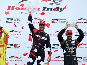 Helio Castroneves (2nd,) Will Power (1st,) and James Hinchcliffe (3rd,)  celebrate their podium finish during the Honda Indy in Toronto on Sunday July 17, 2016. (Dave Abel/Toronto Sun/Postmedia Network)