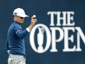 Zach Johnson of the United States acknowledges the crowd after putting on the 18th green during the final round of the British Open Golf Championship at the Royal Troon Golf Club in Troon, Scotland, Sunday, July 17, 2016. (AP Photo/Matt Dunham)
