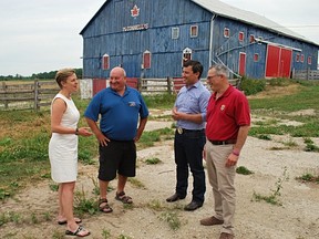 Conservative leadership candidate Kellie Leitch, far left, chats with Bruce-Grey-Owen Sound Conservative MP Larry Miller and fellow Tory leadership hopefuls Michael Chong and Tony Clement during Miller's Appreciation Barbecue at a farm near Kilsyth Sunday afternoon. (DENIS LANGLOIS/THE SUN TIMES)