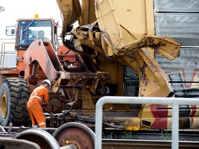 Crews work at the scene of an eight-car train derailment above the 97 Street underpass north of Yellowhead Trail in Edmonton on Sunday, July 17, 2016.