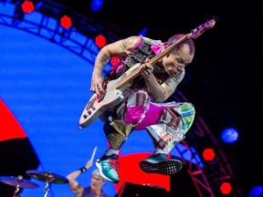 Flea of the Red Hot Chili Peppers jumps as he performs at Ottawa Bluesfest. ERROL MCGIHON / POSTMEDIA