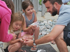 Keith Dempsey/ For The Sudbury Star
Rosalie, Elizabeth and David Laplante admire a butterfly as part of a live release event on Sunday in Bell Park.