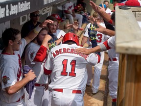 Teammates mob Winnipeg Goldeyes' slugger Reggie Abercrombie in the dugout after lining a two-run homer off the scoreboard in right-centre field in the bottom of the second inning against the visiting Gary SouthShore RailCats at Shaw Park in Winnipeg on Sunday, July 17, 2016. 
Tara Miller/Winnipeg Goldeyes