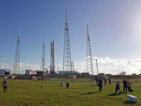 Photographers set up remote cameras preparing to cover the Falcon 9 SpaceX rocket launch at complex 40 at the Cape Canaveral Air Force Station in Cape Canaveral, Fla., Sunday, July 17, 2016. The Falcon 9 scheduled to liftoff early Monday, is headed to the International Space Station with 5,000 pounds of supplies. (AP Photo/John Raoux)
