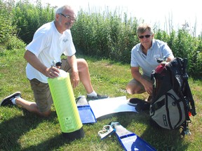 West Elgin divers, left, Bob Carey and Dale Carey found remnants of a pier from the 1875 era in the Eagle area of Lake Erie .