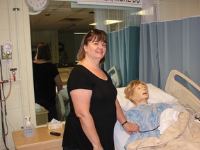 Dr. Marian Luctkar-Flude demonstrates some of the functions of simulation mannequins in the Queen's School of Nursing, for which she won the Excellence in Research Award from the International Nursing Association for Clinical Simulation and Learning at a conference in June. Victoria Gibson for the Whig-Standard/Postmedia Network