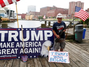 Elan Stoltzfuz stands during a rally for Republican presidential candidate Donald Trump at Settlers Landing Park on Monday, July 18, 2016, in Cleveland. The Republican National Convention starts today. (AP Photo/John Minchillo)