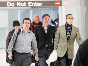 In this Dec. 8, 2011, photo, then-St. Louis Cardinals scouting director Christopher Correa, left, assistant general manager Mike Girsch, center, and general manager John Mozeliak, right, arrive  at Lambert-St. Louis International Airport in St. Louis, Mo., from the baseball winter meetings in Dallas. The former scouting director of the St. Louis Cardinals has pleaded guilty in federal court to hacking the Houston Astros' player personnel database. (Chris Lee/St. Louis Post-Dispatch via AP)